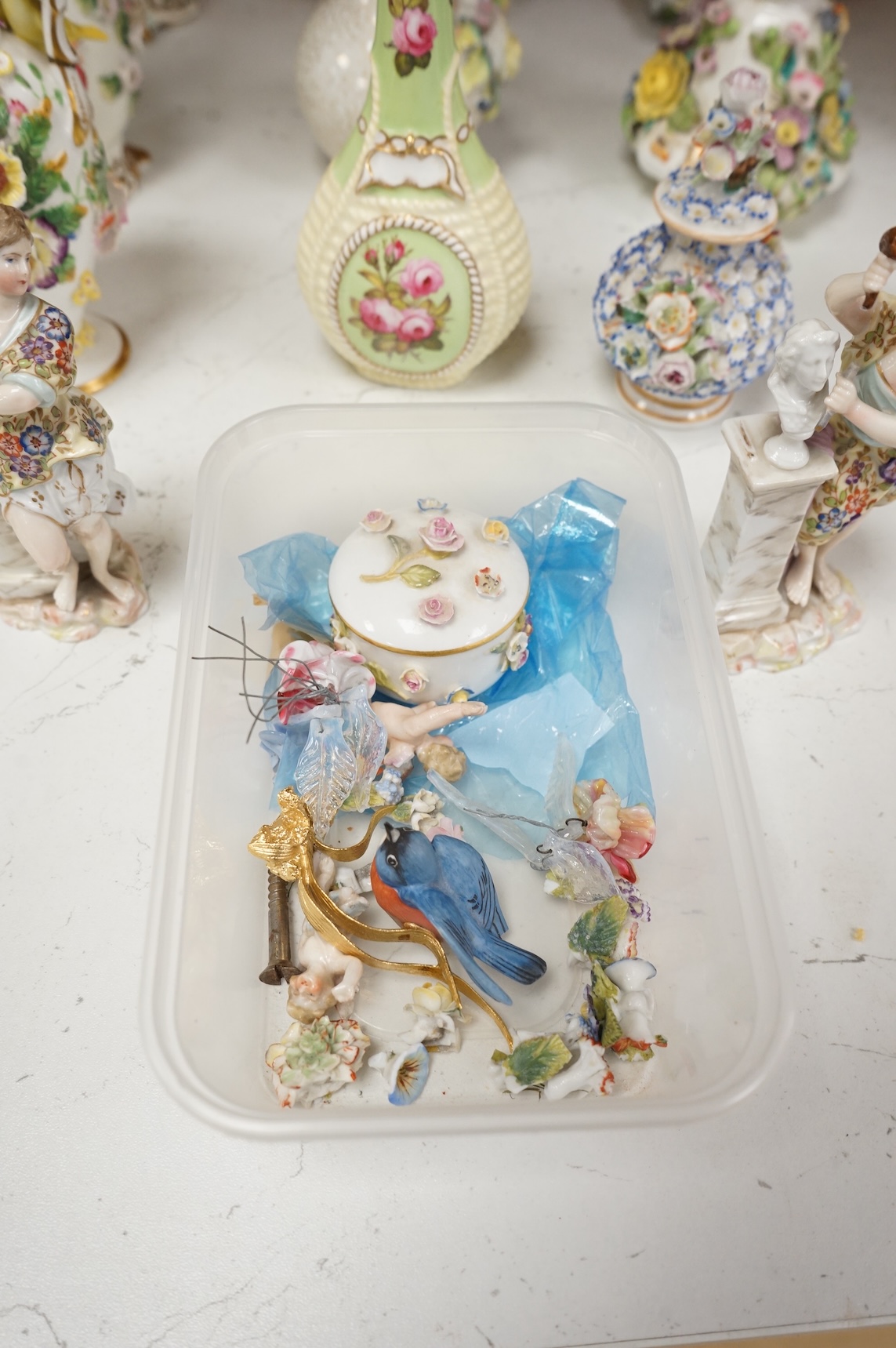 A group of English porcelain flower encrusted scent bottles and yours, Coalport, Minton etc., c.1830-50 together with Continental porcelain figures a wall pocket etc, largest 26cm high